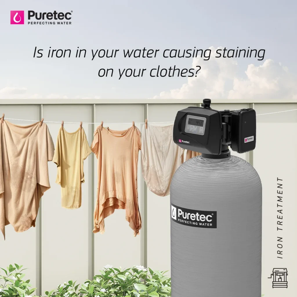 Clothes on a washing line with iron staining beside a Puretec iron treatment system